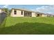 Spacious grassy backyard featuring a well-maintained lawn and glimpses of the house at 2315 Black Lake Blvd, Winter Garden, FL 34787