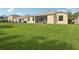 Expansive backyard with lush lawn, fenced perimeter, and glimpses of neighboring properties at 2315 Black Lake Blvd, Winter Garden, FL 34787