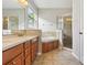 Bathroom featuring double vanity, a soaking tub, and glass-enclosed shower at 2315 Black Lake Blvd, Winter Garden, FL 34787