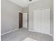 Neutral bedroom with soft carpet and a closet with bi-fold doors at 2315 Black Lake Blvd, Winter Garden, FL 34787