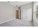 Neutral bedroom featuring soft carpet, closet, and a bright window at 2315 Black Lake Blvd, Winter Garden, FL 34787