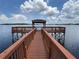 A wooden dock leads to a gazebo on the lake at 2315 Black Lake Blvd, Winter Garden, FL 34787