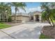 Spacious home featuring a two-car garage and a wide driveway, complemented by lush landscaping at 2315 Black Lake Blvd, Winter Garden, FL 34787