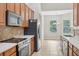 Well-equipped kitchen with stainless steel appliances, granite countertops, and ample cabinet space at 2315 Black Lake Blvd, Winter Garden, FL 34787