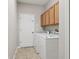 Laundry room with tile flooring and overhead storage cabinets at 2315 Black Lake Blvd, Winter Garden, FL 34787