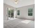 Bright main bedroom with sliding glass doors, large windows, and plush carpeting for a cozy atmosphere at 2315 Black Lake Blvd, Winter Garden, FL 34787