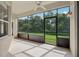 An enclosed patio with glass windows and a screen door provides views of the backyard at 2315 Black Lake Blvd, Winter Garden, FL 34787