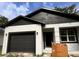 Charming single Gathering house with a garage and modern black and white paint job at 2352 Ross St, Kissimmee, FL 34744