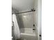 Updated bathroom features a modern vanity, a round mirror, and marble-look tiled walls at 2592 Grassy Point Dr # 106, Lake Mary, FL 32746