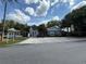Community clubhouse entrance with ample parking, offering a welcoming space for gatherings and events at 2592 Grassy Point Dr # 106, Lake Mary, FL 32746