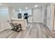 Modern kitchen featuring new stainless steel appliances, white cabinetry, breakfast bar, and wood-look flooring at 2592 Grassy Point Dr # 106, Lake Mary, FL 32746