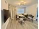 Bright living room features modern lighting, comfortable seating, neutral tones, and wood-look flooring at 2592 Grassy Point Dr # 106, Lake Mary, FL 32746