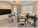 Bright living room features modern lighting, comfortable seating, neutral tones, and wood-look flooring at 2592 Grassy Point Dr # 106, Lake Mary, FL 32746