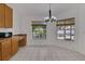 Bright dining area featuring a modern chandelier and a view of the backyard at 2674 Sugar Pine Run, Oviedo, FL 32765