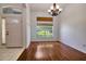 Bright entryway featuring hardwood floors, a large window, and a traditional chandelier at 2674 Sugar Pine Run, Oviedo, FL 32765