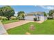 Home exterior with brick driveway, verdant lawn, and partial white fence at 2674 Sugar Pine Run, Oviedo, FL 32765