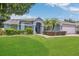 Well-maintained single-story home featuring a lush green lawn and carefully trimmed hedges at 2674 Sugar Pine Run, Oviedo, FL 32765
