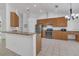 Open kitchen with stainless steel appliances, granite countertops, and stylish cabinetry at 2674 Sugar Pine Run, Oviedo, FL 32765