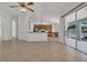 Spacious living room featuring tile flooring and an open view to the kitchen and outdoor patio at 2674 Sugar Pine Run, Oviedo, FL 32765
