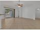 Inviting living room with tile flooring, a ceiling fan, and sliding glass doors to the outdoors at 2674 Sugar Pine Run, Oviedo, FL 32765
