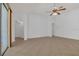 Bright living room with neutral tile floors, a ceiling fan, and sliding glass doors at 2674 Sugar Pine Run, Oviedo, FL 32765