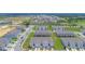 An aerial view of new construction townhomes with modern architecture, garages, and community greenspace at 275 Blueberry Ln, Davenport, FL 33837