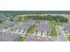 This high-angle shot exhibits the community's townhomes with garages, sidewalks, and green spaces at 275 Blueberry Ln, Davenport, FL 33837