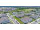 An aerial view of townhomes featuring manicured lawns, sidewalks, and plenty of parking at 275 Blueberry Ln, Davenport, FL 33837