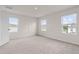 Neutral bedroom with three windows providing natural light and neutral carpeting at 275 Blueberry Ln, Davenport, FL 33837