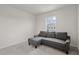 A stylish gray sofa sits in a carpeted bedroom with bright window light at 275 Blueberry Ln, Davenport, FL 33837