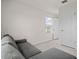 Carpeted bedroom features bright natural light, a gray sofa, and a closet at 275 Blueberry Ln, Davenport, FL 33837