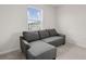 A comfy gray sofa sits in a carpeted bedroom with a bright window view at 275 Blueberry Ln, Davenport, FL 33837