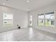 Bonus room with tile flooring, two windows, and a glass door leading to the backyard at 275 Blueberry Ln, Davenport, FL 33837