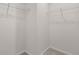 A walk-in closet features white wire shelves and carpeted floor at 275 Blueberry Ln, Davenport, FL 33837