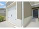 View of the garage and front entry of the townhome at 275 Blueberry Ln, Davenport, FL 33837