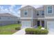 Desirable townhome with a single-car garage and well-maintained lawn at 275 Blueberry Ln, Davenport, FL 33837