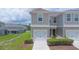 Attractive townhome featuring a one-car garage and manicured landscaping at 275 Blueberry Ln, Davenport, FL 33837