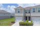 Stylish townhome showcasing a one-car garage and neat curb appeal at 275 Blueberry Ln, Davenport, FL 33837