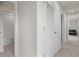 Hallway featuring carpeted floors and access to a bathroom and living room at 275 Blueberry Ln, Davenport, FL 33837