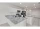 Well-lit kitchen boasts granite countertops, stainless steel appliances, and modern white cabinets at 275 Blueberry Ln, Davenport, FL 33837