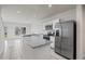 Open kitchen with granite countertops, stainless steel appliances, and a refrigerator at 275 Blueberry Ln, Davenport, FL 33837