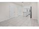 Spacious living room with tile flooring, white doors, and a modern staircase at 275 Blueberry Ln, Davenport, FL 33837