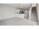 Open concept living area with tile floors, white walls, and stairs to the second floor at 275 Blueberry Ln, Davenport, FL 33837