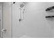 Bright shower featuring white tiles and a shower head with a mounted spray attachment at 275 Blueberry Ln, Davenport, FL 33837
