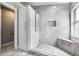 A luxurious walk-in shower featuring marble tile and a shower bench at 2767 Aragon Ter, Lake Mary, FL 32746
