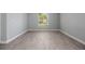 Bedroom showcasing beautiful wood-look floors, gray walls and a bright window view at 2767 Aragon Ter, Lake Mary, FL 32746