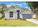 Charming single-Gathering home featuring a two-car garage, arched windows and landscaped front yard at 2767 Aragon Ter, Lake Mary, FL 32746