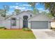 Charming single-Gathering home featuring a two-car garage, arched windows and landscaped front yard at 2767 Aragon Ter, Lake Mary, FL 32746