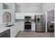 Bright kitchen featuring stainless steel appliances, white cabinetry and laundry space at 2767 Aragon Ter, Lake Mary, FL 32746