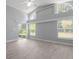 Bright living room with vaulted ceiling and large windows providing natural light, complemented by stylish, neutral-toned flooring at 2767 Aragon Ter, Lake Mary, FL 32746